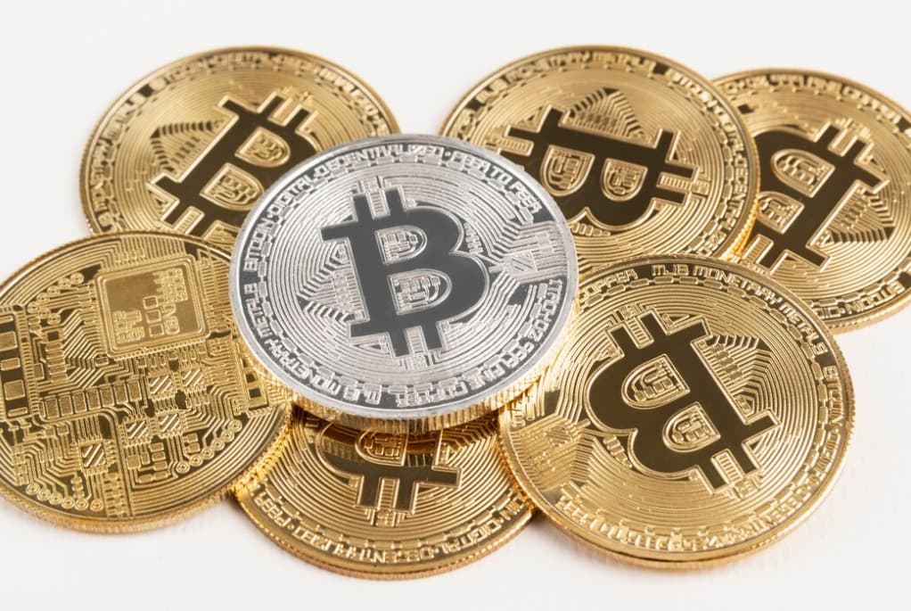 gold coins and silver on top of it on a white table